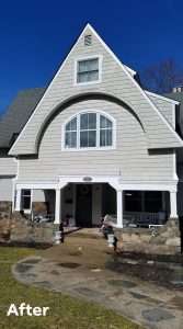 a house with clean siding after being serviced with whole house pressure washing